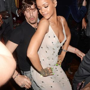 Transformation: Rihanna changed into a plunging semi-sheer gown as she let loose at a British Fashion Awards after-party with photographer Steve Klein at the Oscar Wilde Bar in the Hotel Café Royal in London on Monday