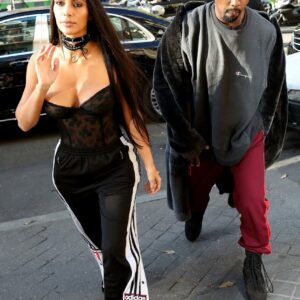 Kim Kardashian paired a black lace corset with a pair of Adidas poppers for a Paris fashion show