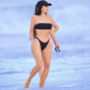 Making a splash! Kim Kardashian put on a very bootylicious display while frolicking off the beaches of Malibu in an itsy bitsy thong bikini on Monday